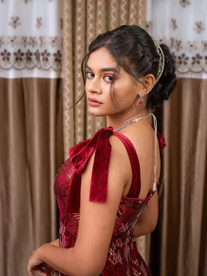 A student's work on a modern party or reception look, showing her skill in creating elegant updos and soft glam makeup.