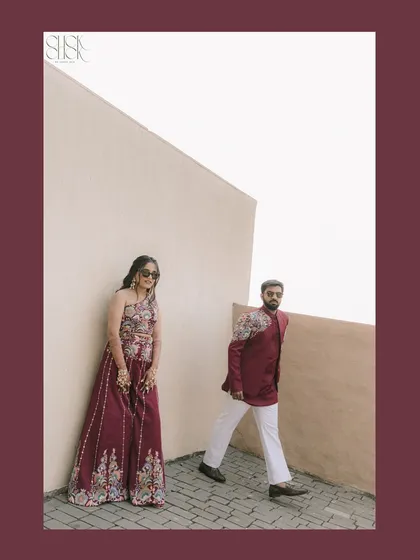An action shot of the couple, with him walking past as she leans against the wall. It creates a dynamic and editorial feel.