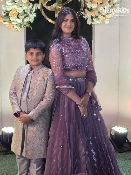 A sweet moment between mother and son, with him looking sharp in his custom-designed Indo-western sherwani. Our outfits are made for making memories.