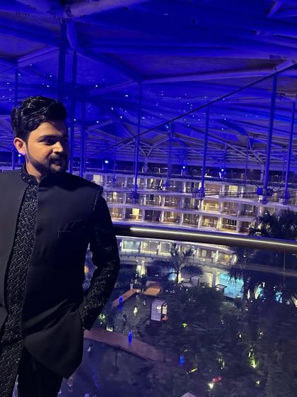 Another view of the blue Indo-western. The asymmetrical cut of the jacket and the detailed embroidery are clearly visible here.