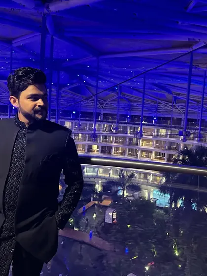 Another view of the blue Indo-western. The asymmetrical cut of the jacket and the detailed embroidery are clearly visible here.