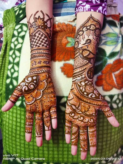 A lovely design for a family member, perhaps for the 'Bhai ki shaadi'. It features a peacock on one arm and a personalized Hindi script on the other, with beautiful mandala work on the palms.