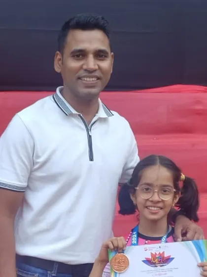 A proud coach with a proud student. Sanvi Bhalerao smiles with her bronze medal from the Parle Mahotsav. We believe the bond between a coach and student is key to success.