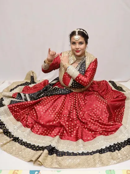The anarkali's expansive ghera is on full display, creating a beautiful canvas around the seated dancer. I design these costumes to be as impactful in moments of stillness as they are in motion.