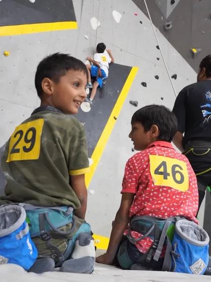 A moment of friendship between climbs. Our kids' competitions are a great place for young climbers to meet their tribe, share beta, and cheer each other on.