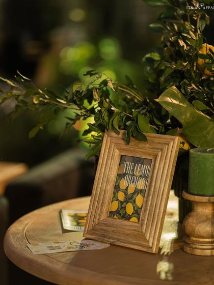 A small, thoughtful detail: a framed 'The Lemon Orchard' print on a side table, reinforcing the unique event theme.