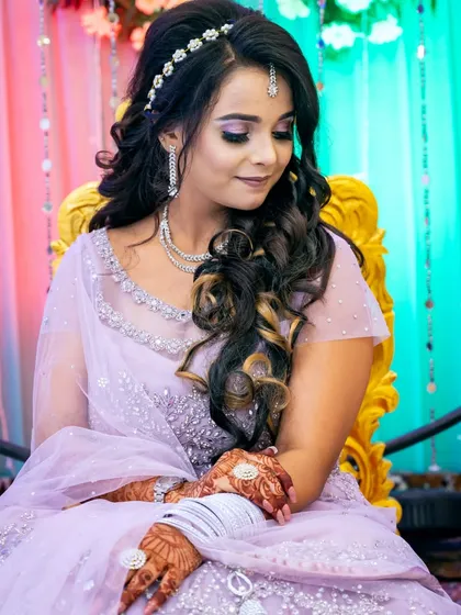 A graceful portrait of the bride-to-be, looking down with a gentle smile.