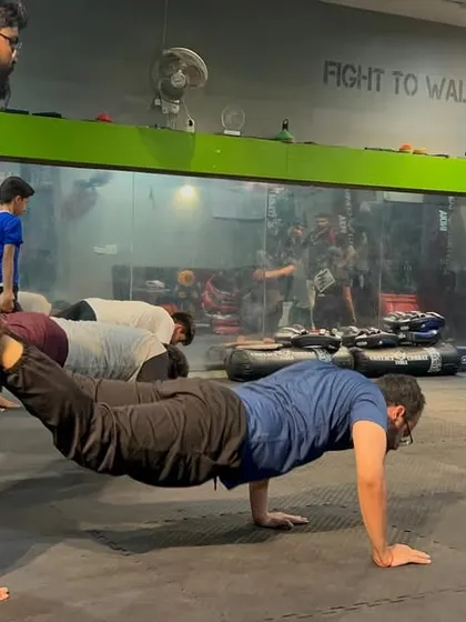 This isn't just a push-up; it's a test of strength and teamwork. Partner drills like this build the physical resilience and trust needed to train effectively and safely.