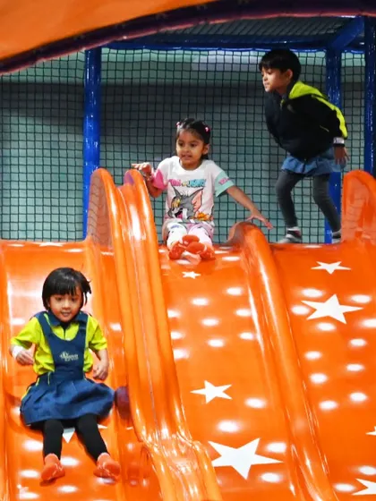 Students having a fantastic time on the slide during their school outing. It's a great way to combine physical activity with fun.