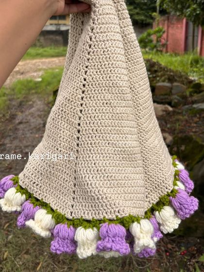 The blanket bouquet partially unfurled, showing the beautiful craftsmanship of the crochet blanket itself.