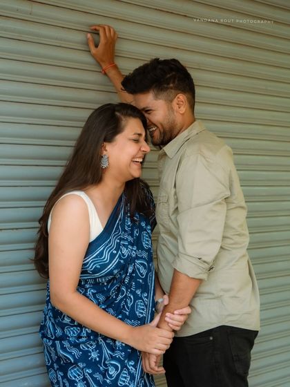 Capturing the simple joy of sharing a moment together. This urban photoshoot uses a bold, colorful backdrop to highlight the couple's connection.
