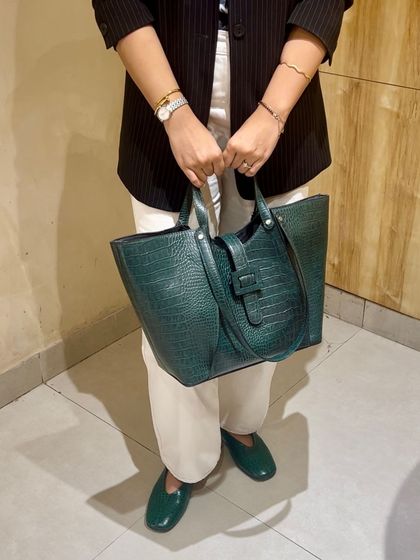Making Sunday work looks fun with our Madison Tote in a deep green croc-print. The buckle detail and spacious interior make it a stylish and practical choice.