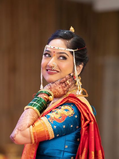 A stunning bridal portrait. The makeup is flawless, with a focus on the eyes and a perfectly matching lip color, making her look like a queen on her special day.