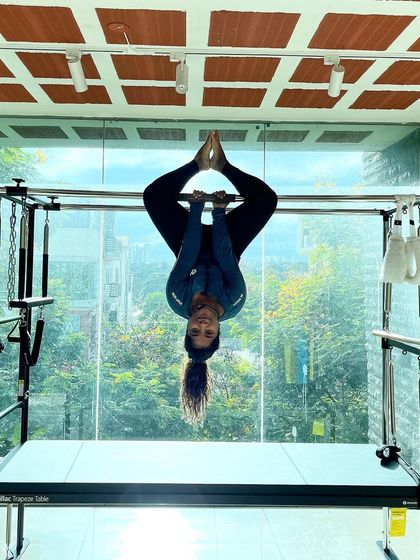 Happiness should be a daily habit. This client is beaming with joy as she masters this inverted hanging pose on the Cadillac.