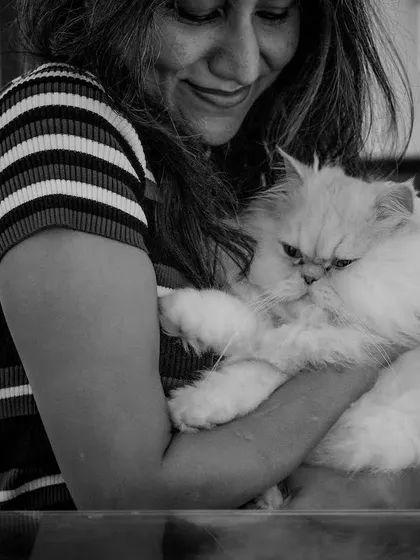 A heartwarming black and white photo with a fluffy Persian cat, adding a personal and relatable touch to the 'Geeky Girl' theme.