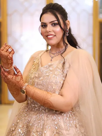A beautiful engagement look in a champagne-colored gown. The makeup is soft and glamorous, with a focus on the eyes.