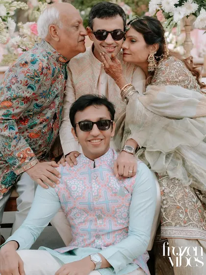 The pure joy of a family huddle during a celebration. These candid moments, full of laughter and genuine affection, are the memories we aim to preserve forever. This is a perfect example of natural family photography at events.