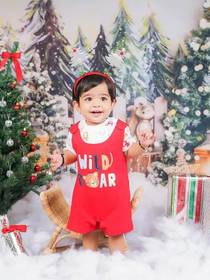 A joyful moment captured amidst the Christmas presents and snow. I love seeing the kids' excitement during these festive sessions.
