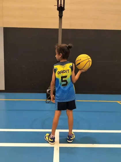 Aadit, one of our young ballers, looking ready to hit the court in his new Maniac Sportz jersey.