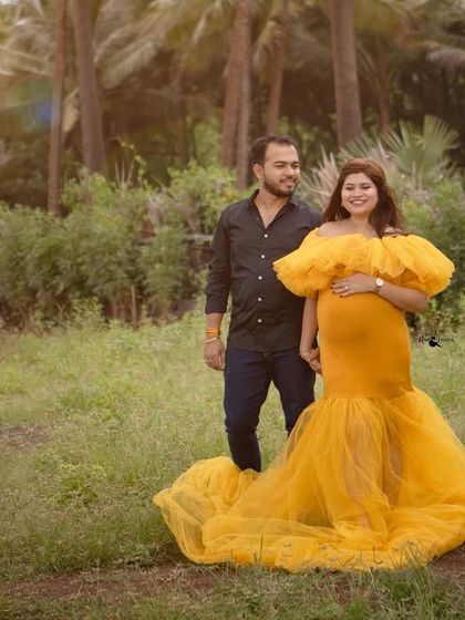 Taking the glamour outdoors. This beautiful yellow gown stands out against the natural greenery, creating a vibrant and joyful portrait of the couple.