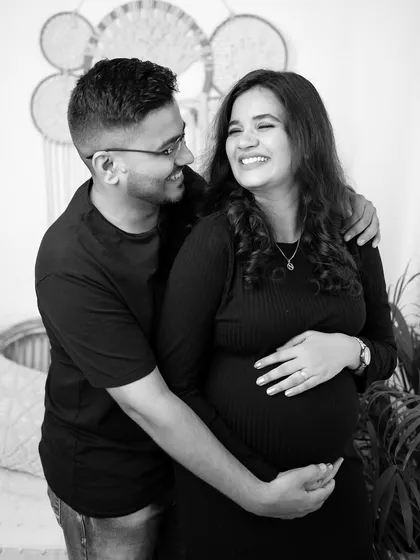 A black and white photo of a couple sharing a laugh. Candid moments like this are the heart of a lifestyle session, showing your genuine connection.