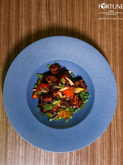 An artfully plated dish of stir-fried vegetables, showcasing the vibrant colors and fresh ingredients we use in our kitchen.