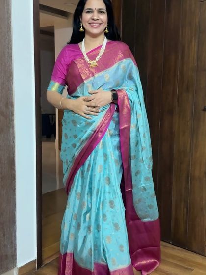 This light blue silk saree with a pink border is a classic combination. It's elegant, timeless, and perfect for any traditional occasion.