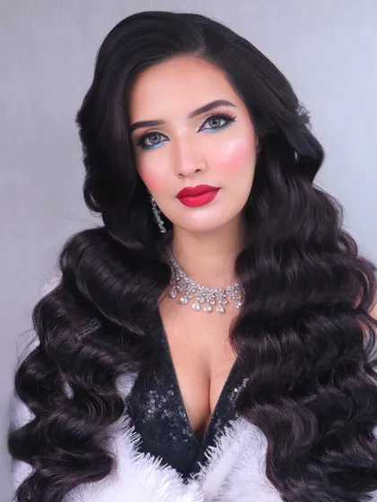 This shot showcases the voluminous Hollywood waves and the overall star-quality of the look.