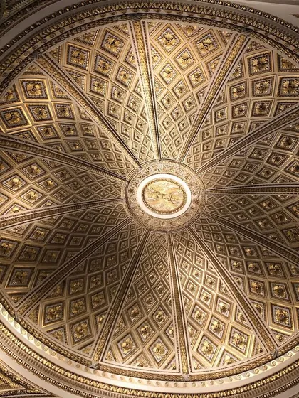 An ornate, gilded dome ceiling from a historic European building. The geometric precision and incredible detail are a testament to timeless craftsmanship. Architecture like this inspires me to bring a sense of history and grandeur into the spaces I design.