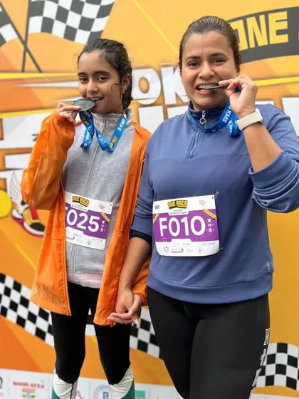 A mother and daughter with their finisher medals. A proud moment for both.