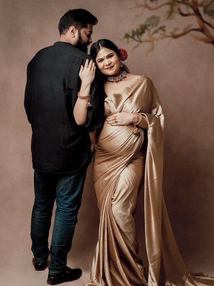A sweet and tender moment between this expecting couple. The mom-to-be looks radiant in her golden saree, and their connection is beautiful to see.