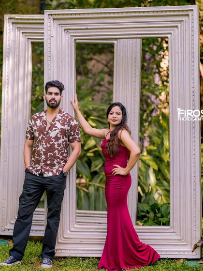 The giant white photo frames offer a fun and creative way to frame your couple portraits in the garden.