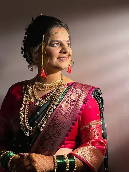 A profile shot showing the elegant bridal bun (Khopa) and the traditional jewellery that frames the face.