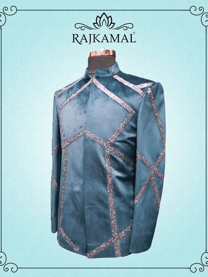 A teal blue velvet jacket with geometric sequin work. This is a bold and magical piece of groom's wear, perfect for a glamorous reception.