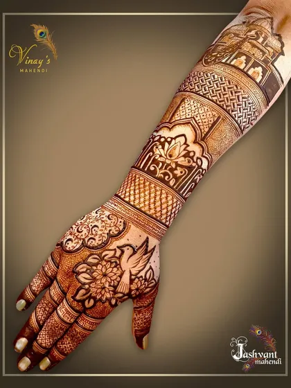 This back-of-hand design features a bird motif on the palm and architectural elements on the forearm, telling a story along the arm.