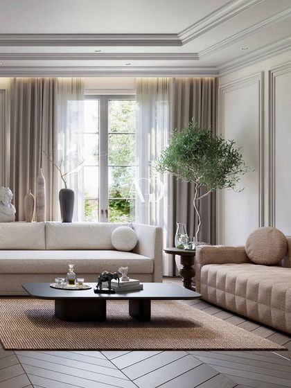 A close-up on one of the seating arrangements, showcasing the mix of a modern quilted sofa with a more traditional, soft-lined couch. The play of textures and forms adds visual interest.