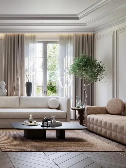 A close-up on one of the seating arrangements, showcasing the mix of a modern quilted sofa with a more traditional, soft-lined couch. The play of textures and forms adds visual interest.