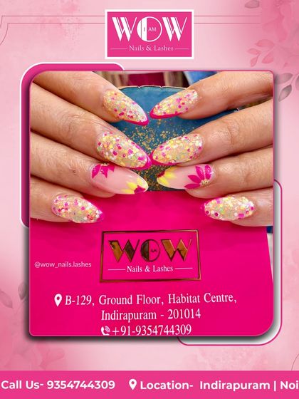 A bright and playful design on almond-shaped extensions. This look combines a sheer, glittery base with pops of yellow and pink, featuring fun floral details.