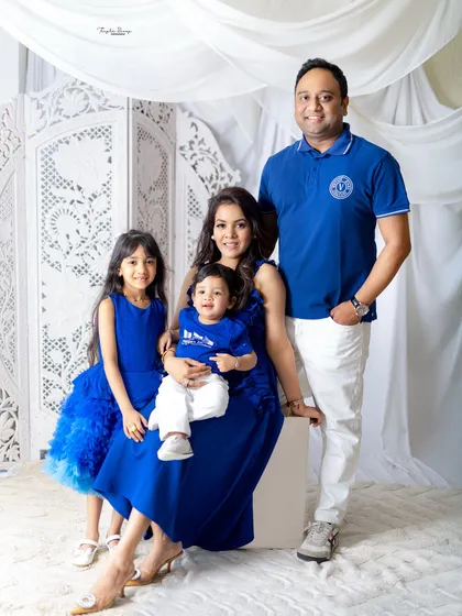 A classic posed family portrait. Everyone is looking at the camera, creating a perfect photo for the wall or to share with loved ones.