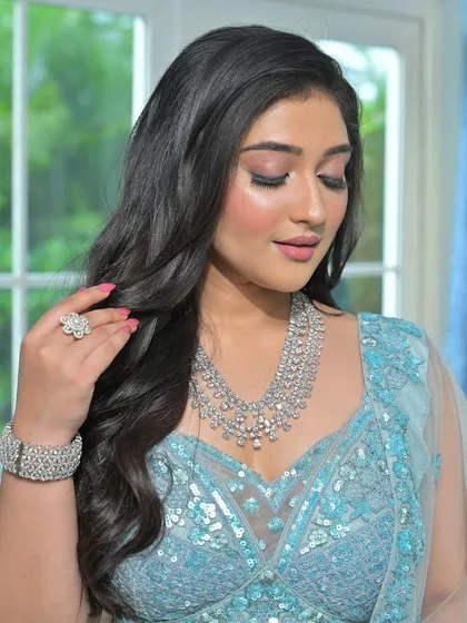 A close-up of a stunning layered zircon necklace, paired with a matching bracelet and ring. This complete set offers a glamorous and cohesive look, perfect for a bride's reception.