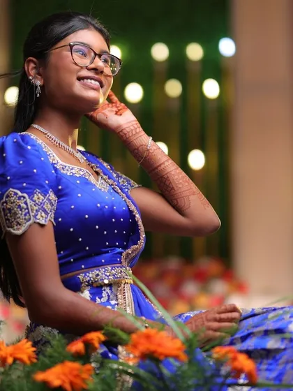 A close-up of our young client in her royal blue lehenga, her joy infectious.