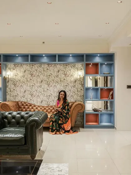 Another view of the living room from image 61, focusing on the seating arrangement and the elegant TV wall panel.