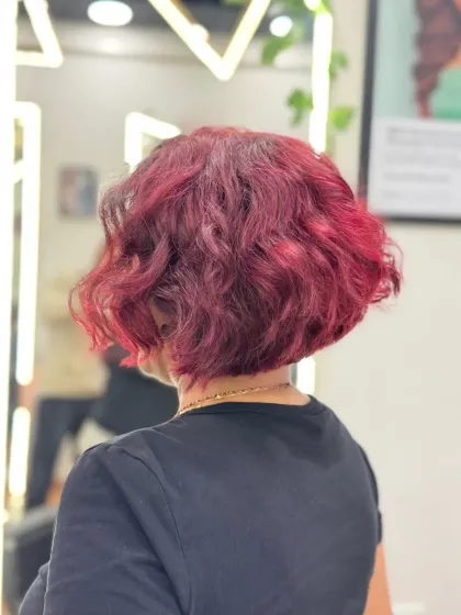 The back view of a warm wine-colored bob. The color is vibrant and the cut is sharp, creating a chic and confident style.