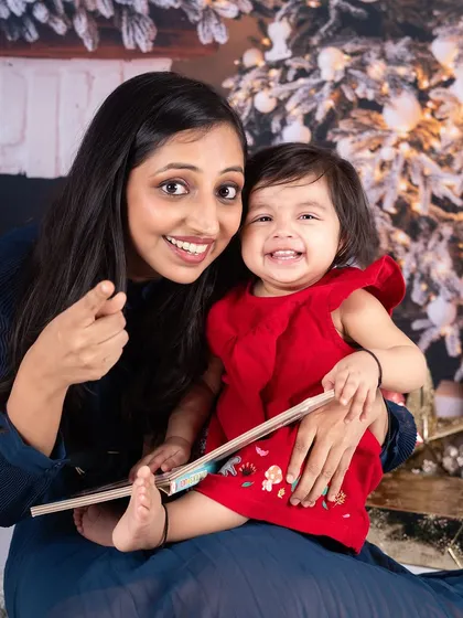 A mother and her giggling baby girl. The joy and connection in this photo perfectly capture the spirit of the season.