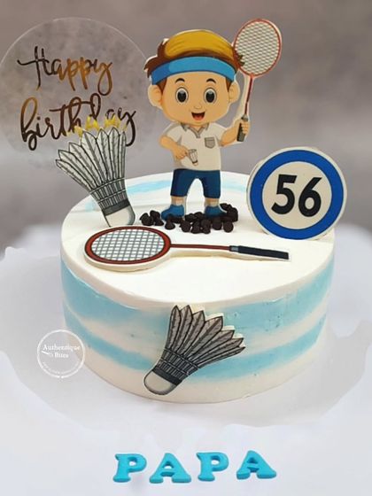 A badminton-themed cake for a 56th birthday. The cake is decorated with rackets, shuttlecocks, and a cartoon player topper.