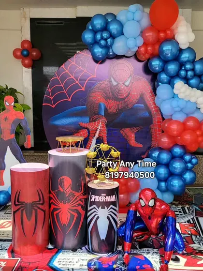 For the superhero fan, I offer a Spider-Man theme. This setup includes a large circular backdrop with Spider-Man graphics, character cutouts, and themed pedestals.