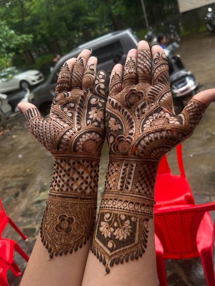 A classic full-hand design with perfect symmetry. Both hands mirror each other with patterns of checks, flowers, and paisleys, creating a balanced and traditional look.