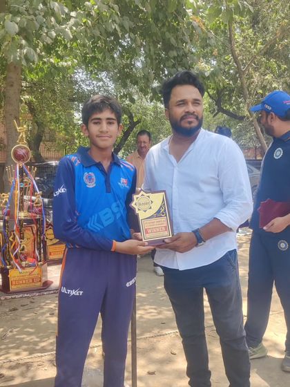 Presenting a winner's plaque to a promising young player. Every award is a milestone in a player's journey.