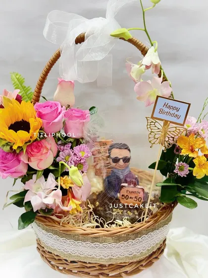 A perfect gift for a 50th birthday, this hamper combines a custom half-figurine cake with a stunning fresh flower basket. The client wanted a cream-free cake, so I made a rich chocolate walnut base.