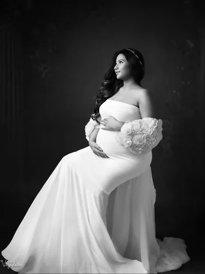 A regal and timeless seated portrait. Monochrome gives it the feel of a classic painting or a vintage photograph.